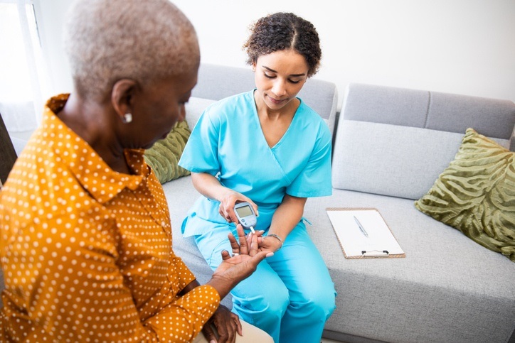 A nurse testing blood sugar